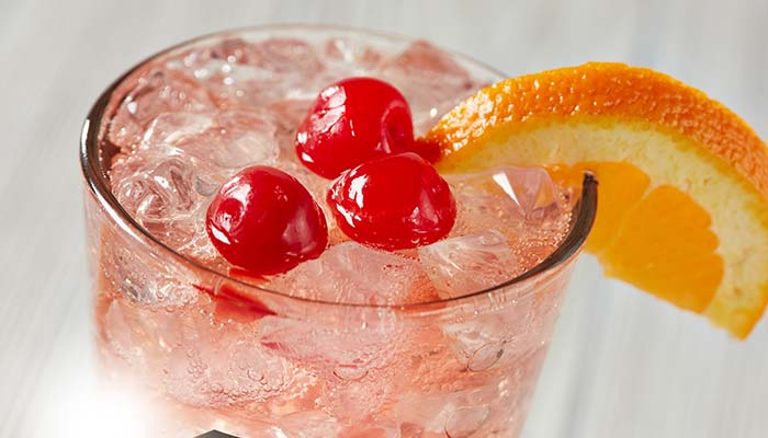 Whiskey or brandy old fashion mix drink bar cocktail topped with cherries and orange slice served at the Fox Valley's best restaurant Waverly Beach