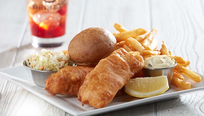 Golden fried fish from Fox Valley's best restaurant menu at Waverly Beach Bar & Grille in Menasha served with a side of coleslaw, bun and lemon