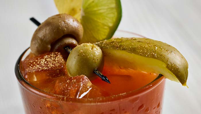 Bloody mary specialty drink garnished with pickled mushroom, olive and pickle spear served at Waverly Beach Bar & Grille restaurant in the Fox Valley Menasha, WI