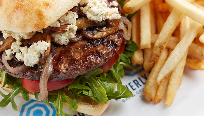 Elk burger topped with fried mushrooms and onions served at Waverly Beach Bar & Grille restaurant in the Fox Valley Menasha, WI